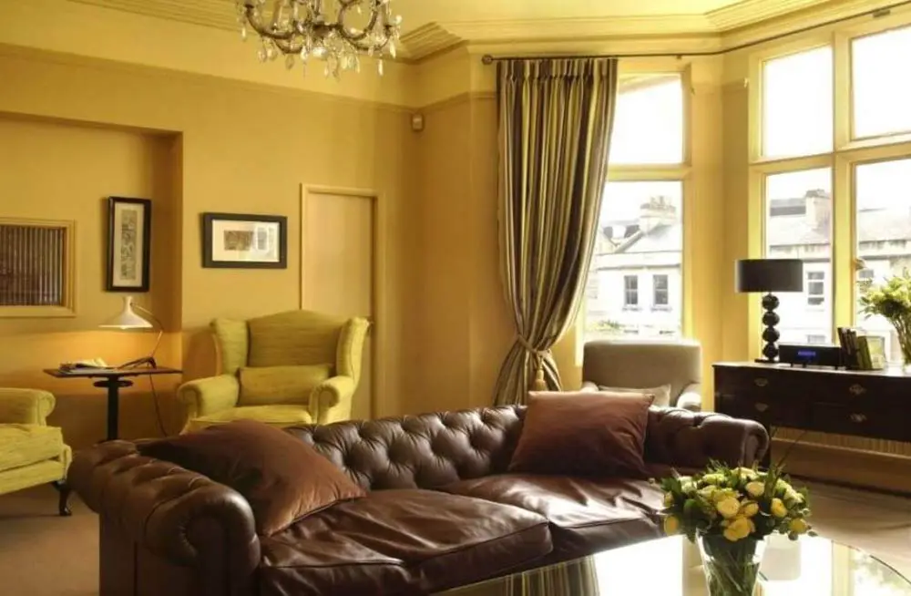brown-leather-sofa-mustard-walls
