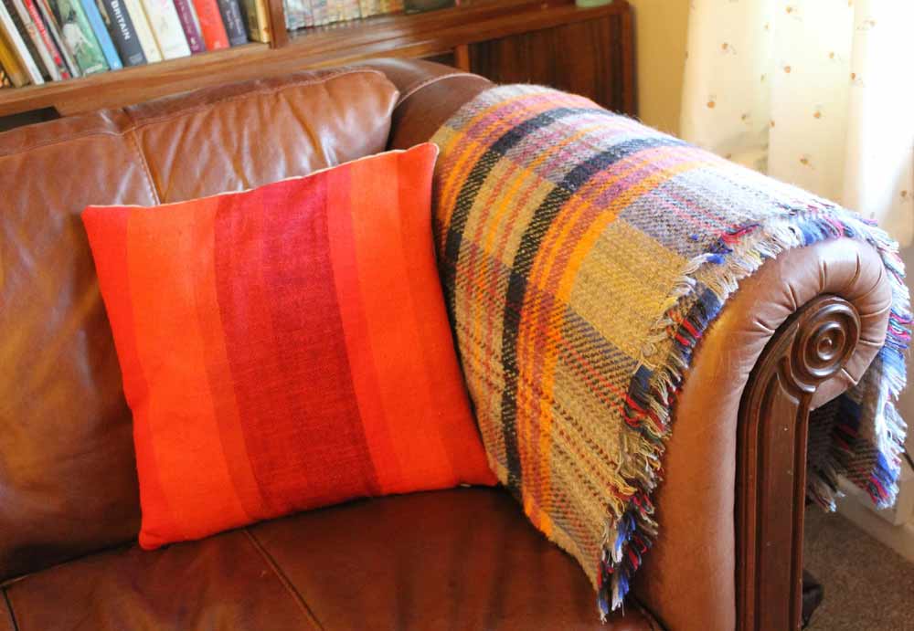 brown-leather-sofa-orange-cushion