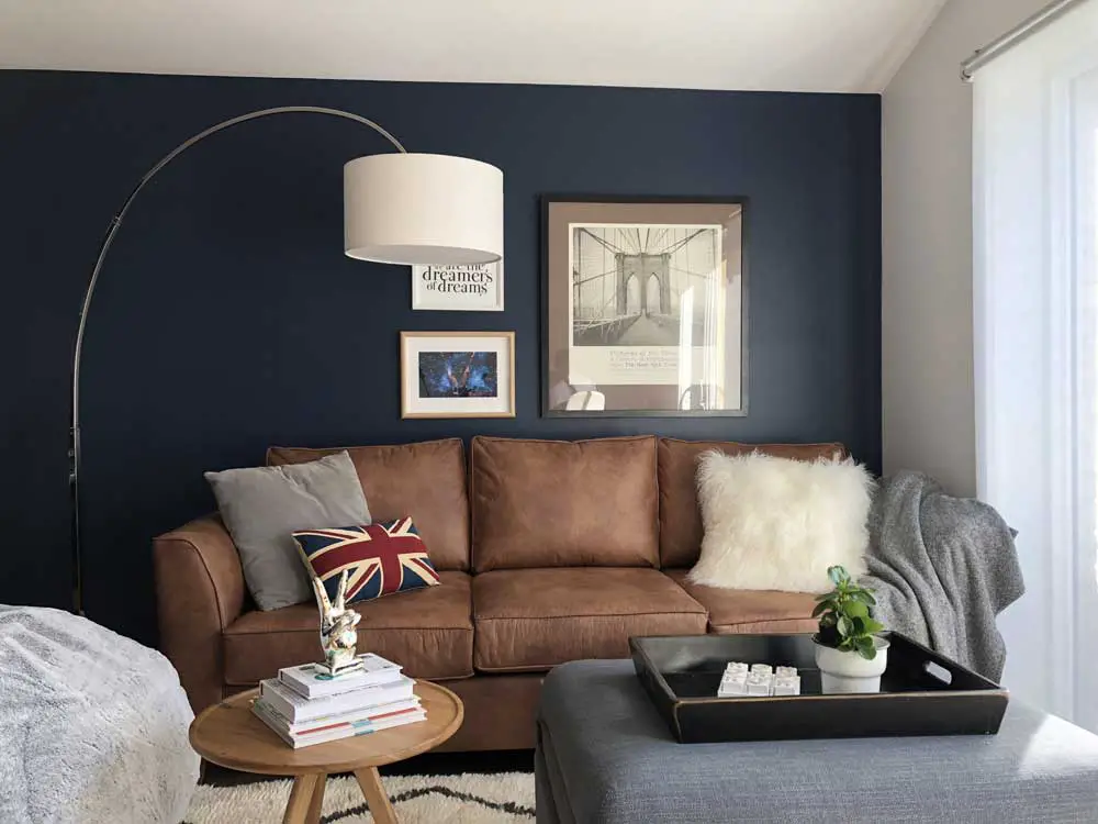brown-leather-sofa-with-grey-navy-blue-wall