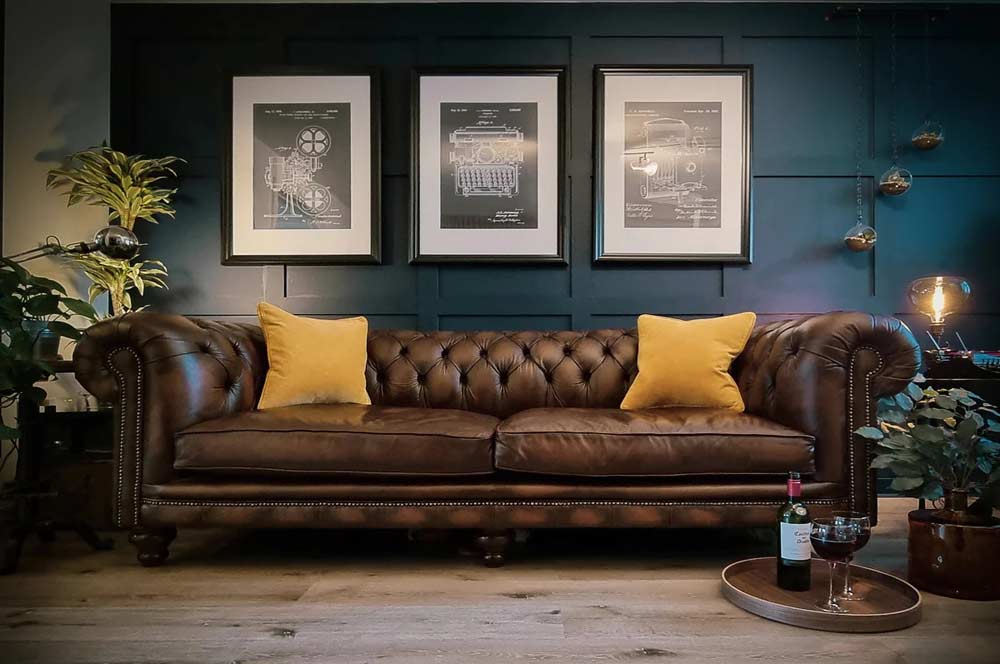 dark-aquamarine-panelled-wall-brown-leather-sofa