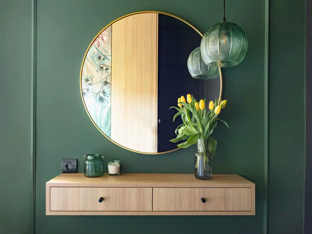 floating drawers with round mirror in hallway