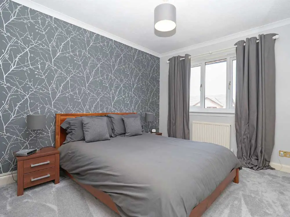 grey bedroom with tree patterned feature wall