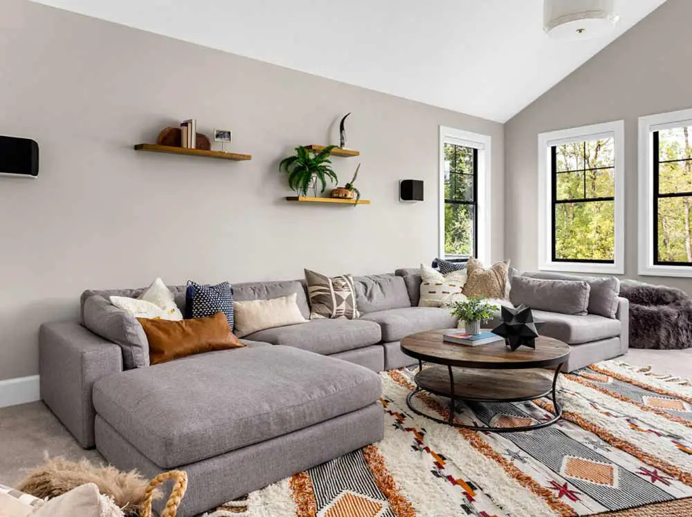 grey-sofa-with-burnt-orange-white-rug