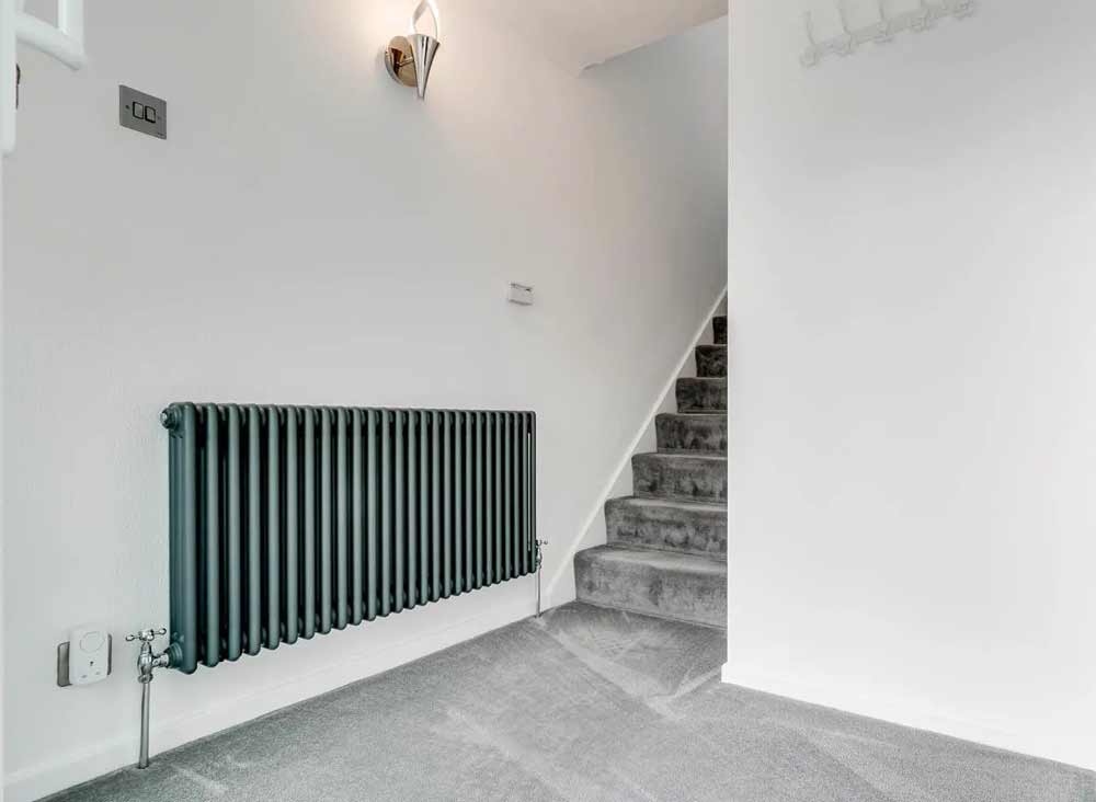 grey-victorian-radiator-in-white-hallway