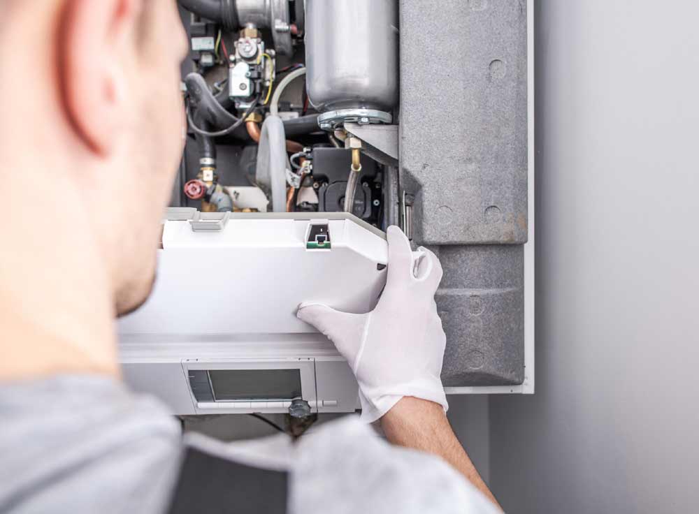 man installing a boiler