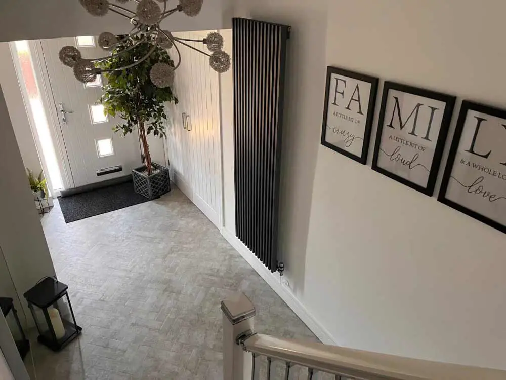 vertical-grey-radiator-in-modern-hallway