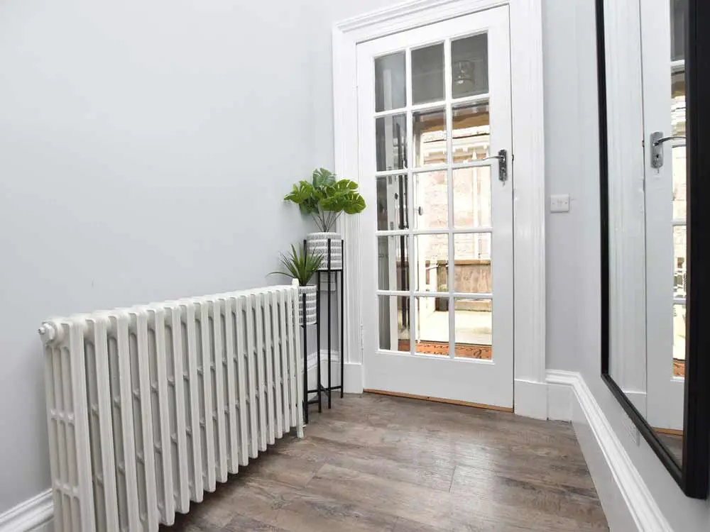 white cast iron radiator in hallway